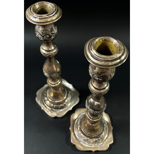 191 - A Pair of silver candlesticks in a scrolled vine design, London, 1925, makers mark rubbed, 28cm high... 