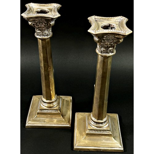 193 - A pair of silver classical octagonal columned candlesticks, Birmingham, 1936, makers mark Britton Go... 