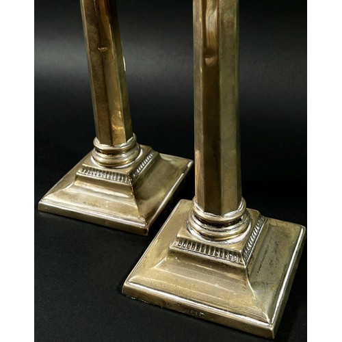 193 - A pair of silver classical octagonal columned candlesticks, Birmingham, 1936, makers mark Britton Go... 