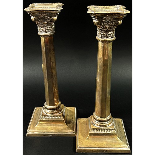 193 - A pair of silver classical octagonal columned candlesticks, Birmingham, 1936, makers mark Britton Go... 