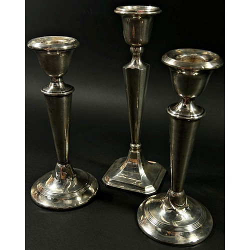 194 - A pair of silver 'V' shaped candlesticks, London, 1919, together with one other, Birmingham, 1923, m... 