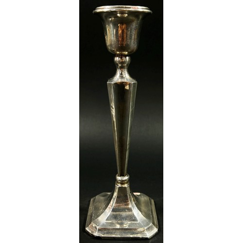 194 - A pair of silver 'V' shaped candlesticks, London, 1919, together with one other, Birmingham, 1923, m... 