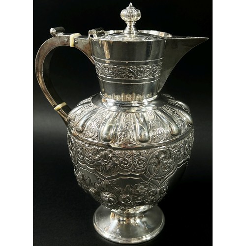 195 - An Edwardian silver wine jug designed with scrolled vines, fruits and flowers, Sheffield, 1903, make... 