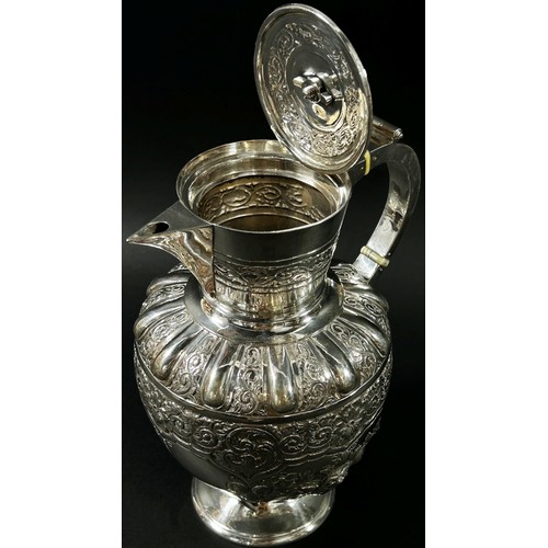 195 - An Edwardian silver wine jug designed with scrolled vines, fruits and flowers, Sheffield, 1903, make... 