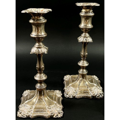 196 - A pair of silver candlesticks in a scalloped detailed design, Birmingham, 1915, makers mark Ellis an... 