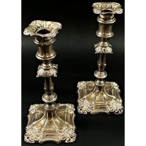 196 - A pair of silver candlesticks in a scalloped detailed design, Birmingham, 1915, makers mark Ellis an... 