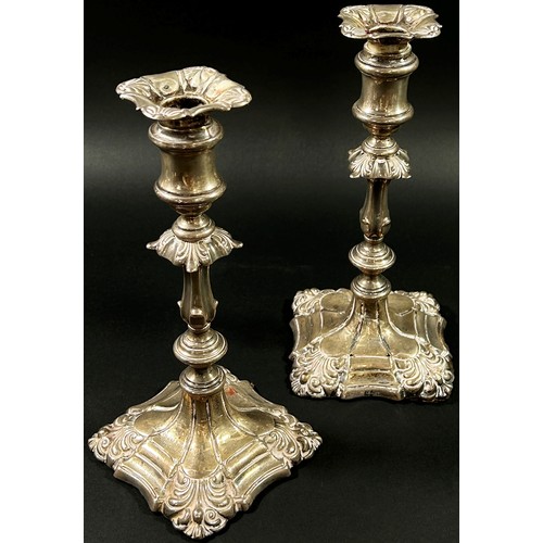 196 - A pair of silver candlesticks in a scalloped detailed design, Birmingham, 1915, makers mark Ellis an... 