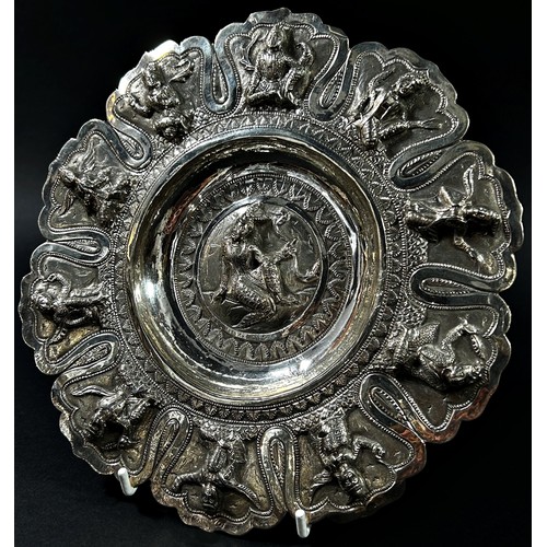 200 - An Indian silver decorated dish with ten figures to the sides and one to the centre, 5.7oz approx