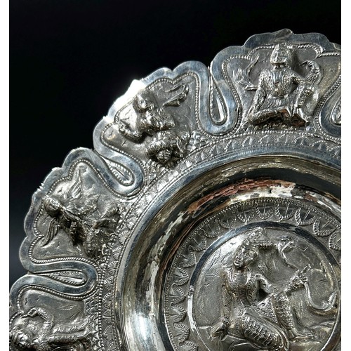 200 - An Indian silver decorated dish with ten figures to the sides and one to the centre, 5.7oz approx