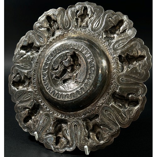 200 - An Indian silver decorated dish with ten figures to the sides and one to the centre, 5.7oz approx