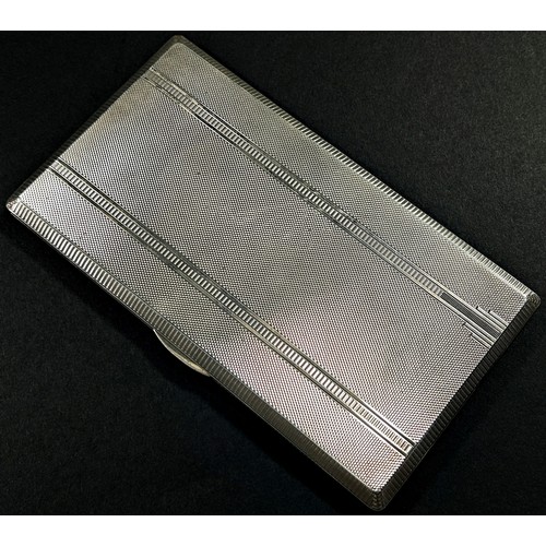 201 - A silver engine turned cigarette case with gilded interior, Birmingham, 1946, makers mark William Su... 