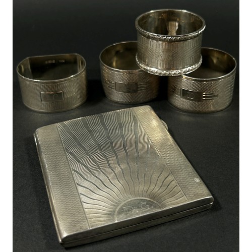 202 - A group of silver pieces to include four napkin rings an initialled silver cigarette case, a fish kn... 