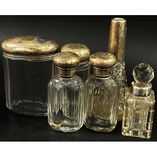 207 - A group of six silver topped dressing table jars of various forms