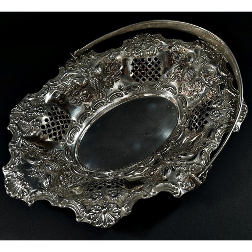 215 - A solid silver swing handle fruit basket in a floral and fruit decorated theme, London, 1900, makers... 