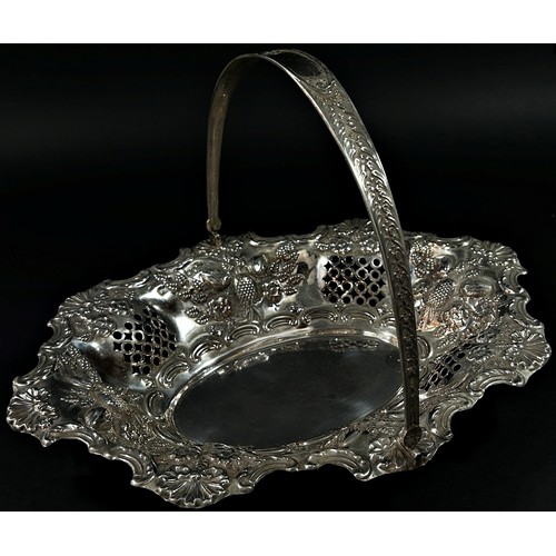 215 - A solid silver swing handle fruit basket in a floral and fruit decorated theme, London, 1900, makers... 