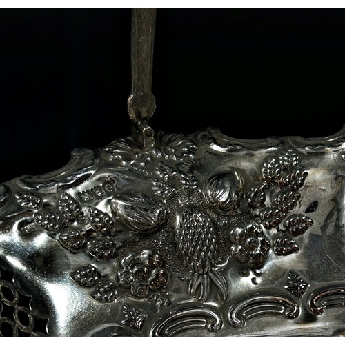 215 - A solid silver swing handle fruit basket in a floral and fruit decorated theme, London, 1900, makers... 