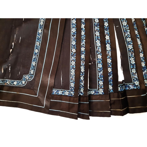 922 - Chinese pleated skirt panel in black silk with embroidered floral bands to front section and edging ... 