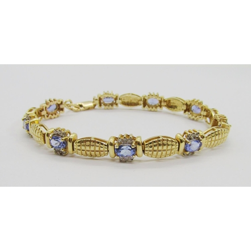 251 - 14ct oval tanzanite and diamond cluster bracelet, 19.5cm L approx, 17.1g