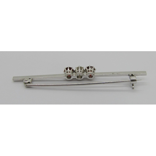 260 - Early 20th century 14ct white gold three stone bar brooch claw set with a diamond and two garnets, s... 