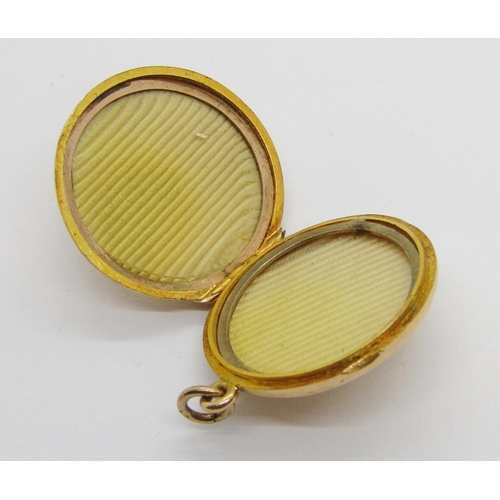 302 - Early 20th century 15ct circular locket set with a sapphire and two diamonds, 2.2cm diameter approx,... 