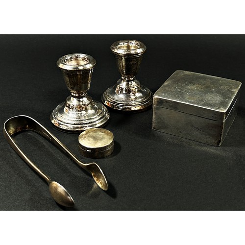 221 - A Chinese silver box stamped initials W.H. 90 (Wang Hing of Hong Kong), two squat silver candlestick... 