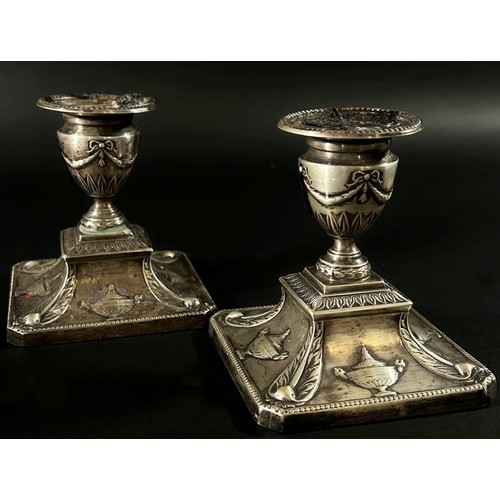 229 - A small pair of silver candlesticks, 10cm high with urn and swag decoration, Sheffield 1908, makers ... 