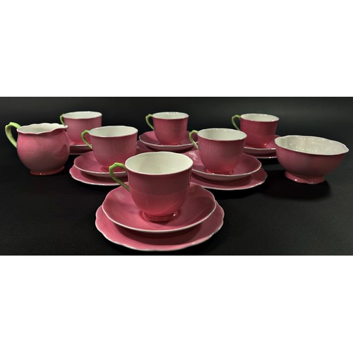 104 - A quantity of pink ground Royal Albert bone china tea wares, the cream jug and cup handles with gree... 