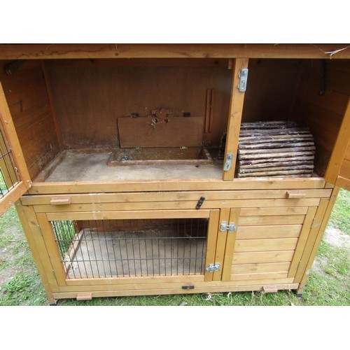 1227 - A two tier wooden rabbit hutch with hinged lid 105 cm high x 120 cm wide