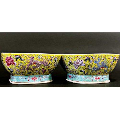 47 - A pair of Chinese enamelled porcelain square footed bowls of squared form, decorated with mythical b... 