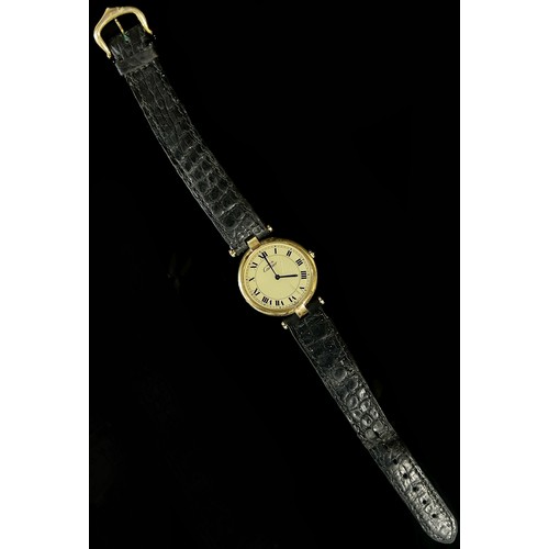 417 - Must de Cartier: A ladies silver gilt wristwatch, with Roman numerals on champaign dial, blue hands,... 