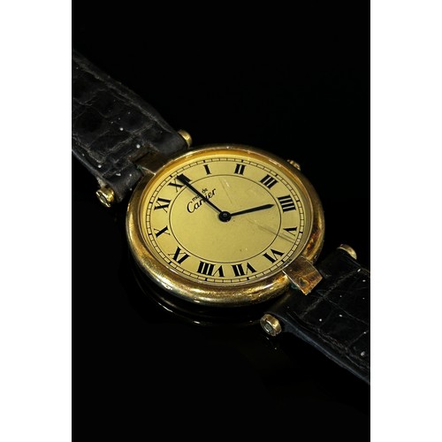 417 - Must de Cartier: A ladies silver gilt wristwatch, with Roman numerals on champaign dial, blue hands,... 