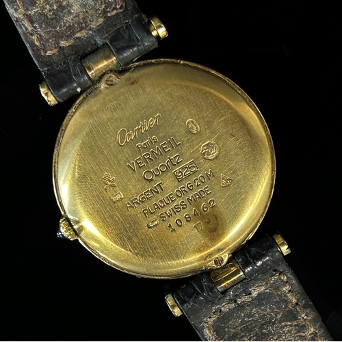 417 - Must de Cartier: A ladies silver gilt wristwatch, with Roman numerals on champaign dial, blue hands,... 