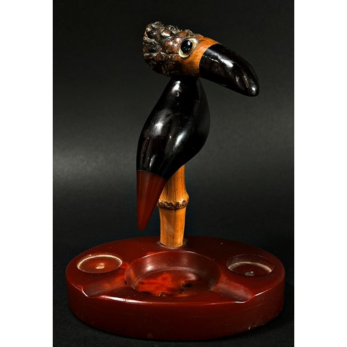 387 - A scarce Art Deco Y Z cherry amber Faturan Nut Bird ash tray, Henry Howell Dunhill, set on a composi... 