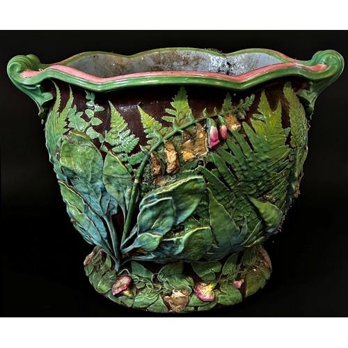 56 - A very large 19th century majolica type moulded earthenware jardinière with scrolled handles and mau... 