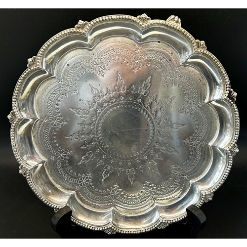 239 - A Victorian silver card tray with scalloped edge and floral engravings, raised on scrolled feet, Lon... 