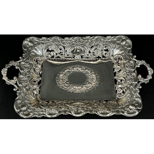 240 - An Edwardian rectangular silver fruit dish with pierced floral sides, raised on a rectangular base, ... 