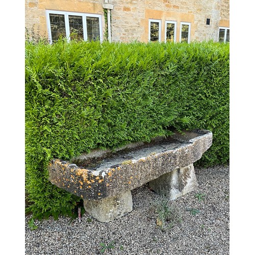 1001 - A shallow weathered natural stone planter / trough of rectangular form, raised on two associated sta... 