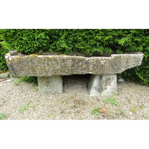 1001 - A shallow weathered natural stone planter / trough of rectangular form, raised on two associated sta... 