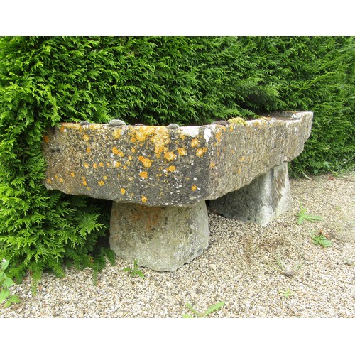 1001 - A shallow weathered natural stone planter / trough of rectangular form, raised on two associated sta... 