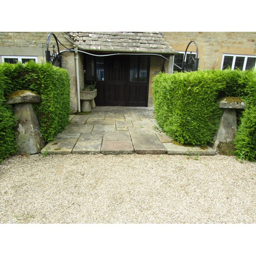 1002 - A tall associated pair of weathered natural staddle stones, each with tapered square caps, 100cm hig... 