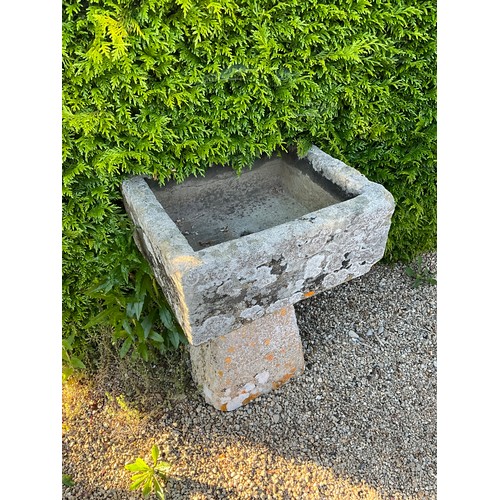 1007 - A small weathered natural stone planter / trough of rectangular form raised on associated tall stadd... 