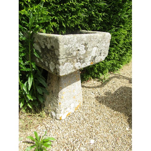 1007 - A small weathered natural stone planter / trough of rectangular form raised on associated tall stadd... 