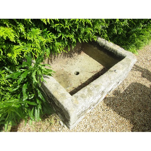 1007 - A small weathered natural stone planter / trough of rectangular form raised on associated tall stadd... 