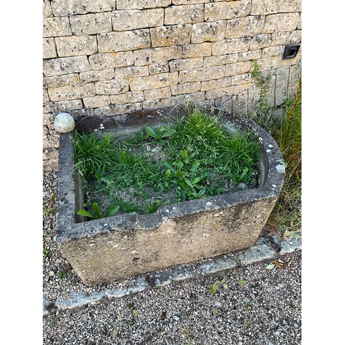 1009 - A weathered natural stone planter / trough of rounded rectangular form with carved channel (damage/l... 