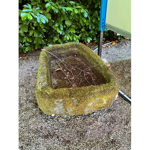 1013 - A weathered lychen covered natural stone planter / trough of rounded rectangular form, thickly hewn,... 