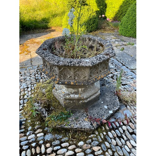 1015 - A large and impressive weathered carved composition sectional stone font / planter of octagonal form... 