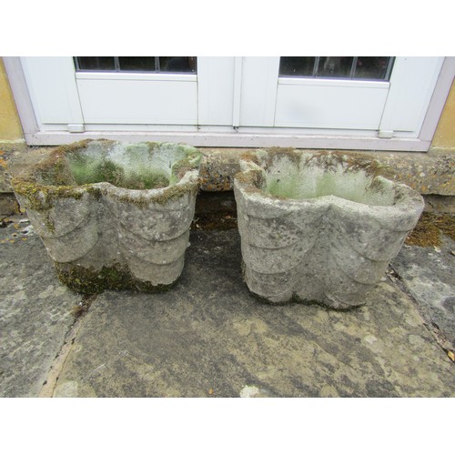 1017 - A pair of weathered composition stone quatrefoil form planters with stepped detail, 26cm high, 39cm ... 