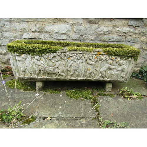 1022 - A weathered and lychen covered composition stone planter of rectangular form with moulded figural de... 