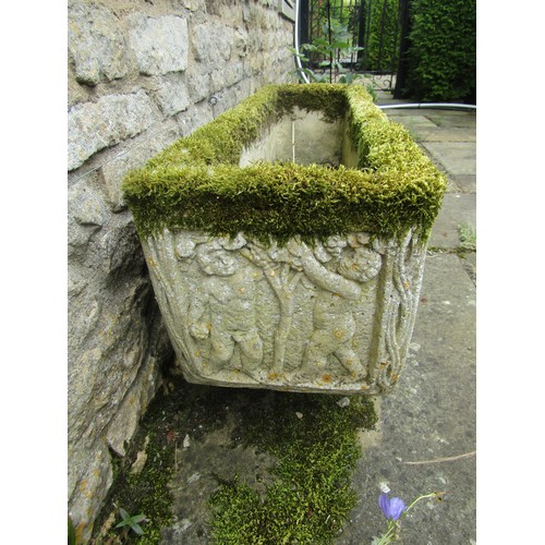 1022 - A weathered and lychen covered composition stone planter of rectangular form with moulded figural de... 