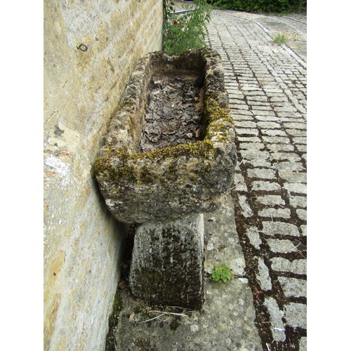 1025 - A weathered and gnarled natural stone planter / trough of rectangular form raised on an associated p... 